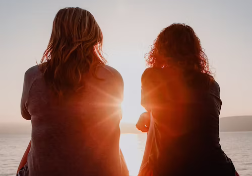 women sitting sunset (1)